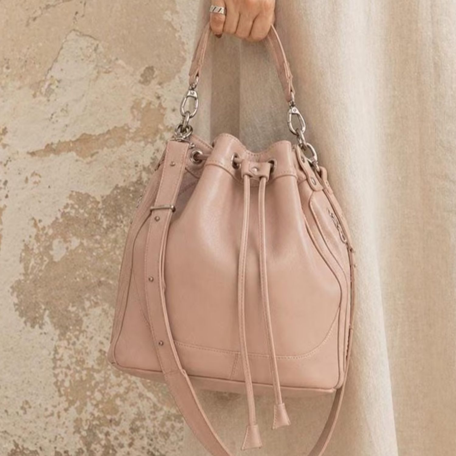Blush Neutral Soft Cinch Bucket Purse With Detachable Carry Loops, Dual Outer Zip Compartments And Structured Flat Base Silhouette Drawstring Bag