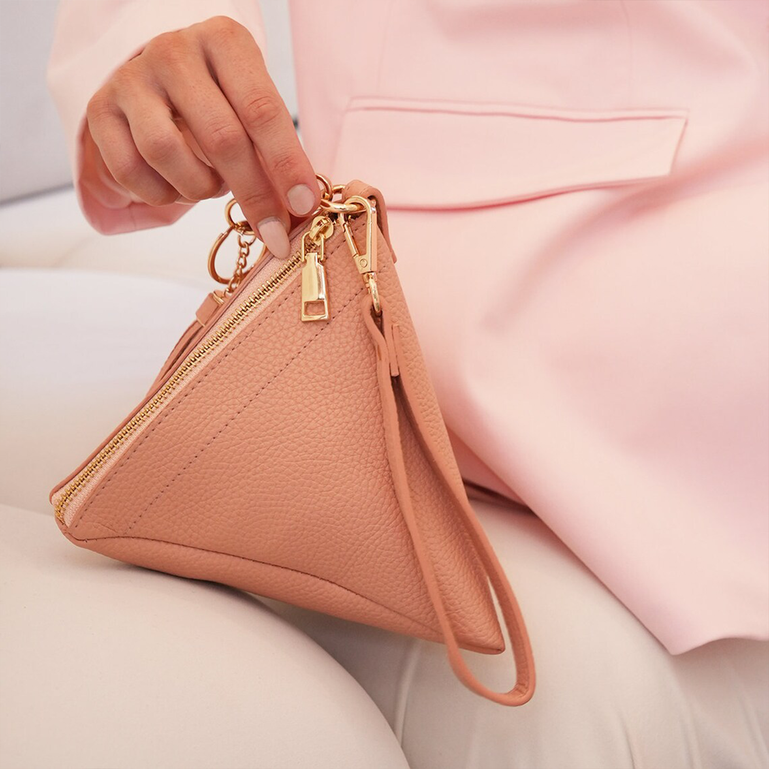 Dual Neutral Tone Geometric Pyramid Wrist Clutch With Gold Zip Hardware, Dangling Fabric Tassel Charm And Slim Matching Wrist Loop