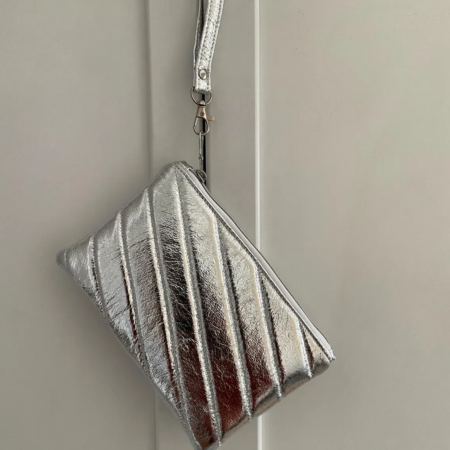 Metallic Silver Diagonal Quilted Padded Zip Pouch With Detachable Wrist Loop Strap And Swivel Metal Clasp Hardware