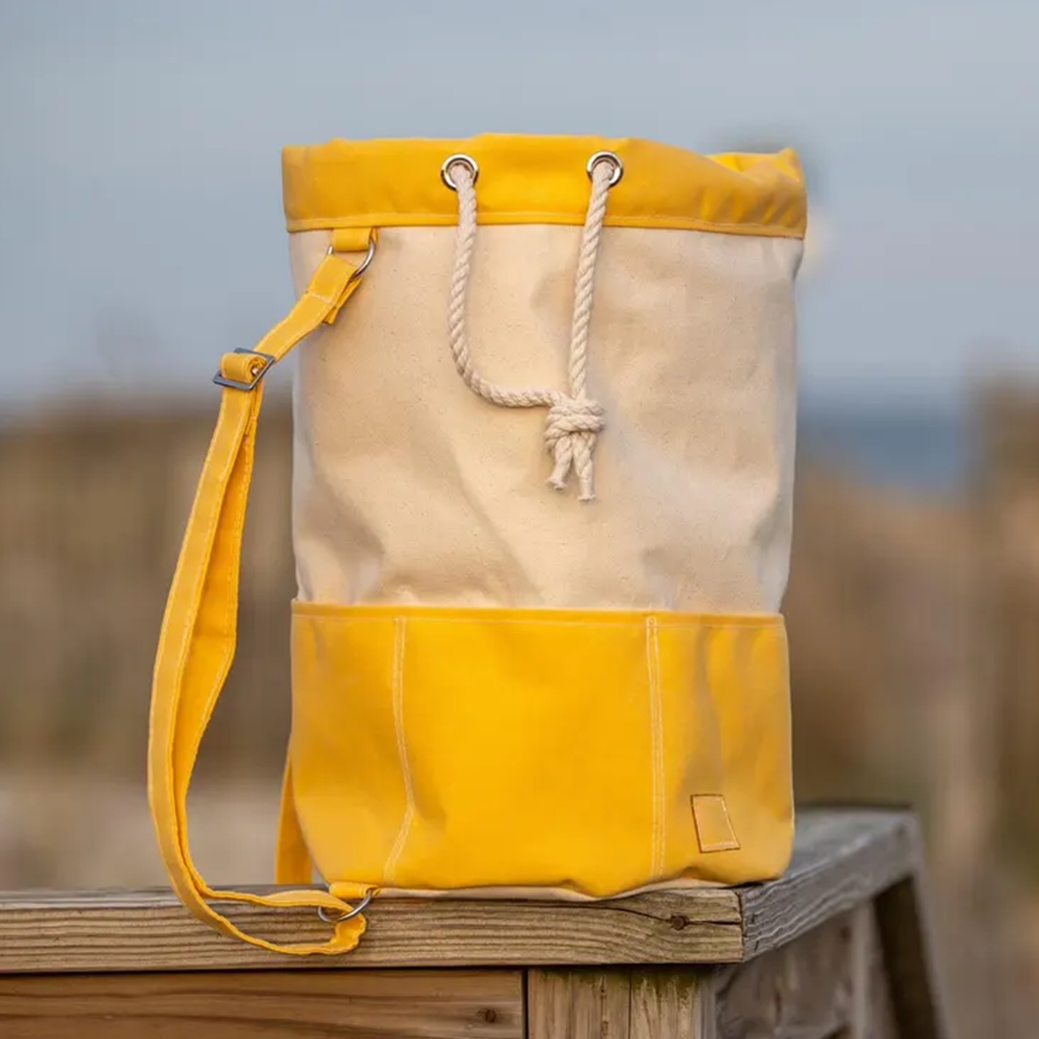 Two-Tone Split Panel Canvas Bucket Backpack With Rolled Cord Drawstring Top, Front Divided Patch Pocket And Solid Color Accent Sections